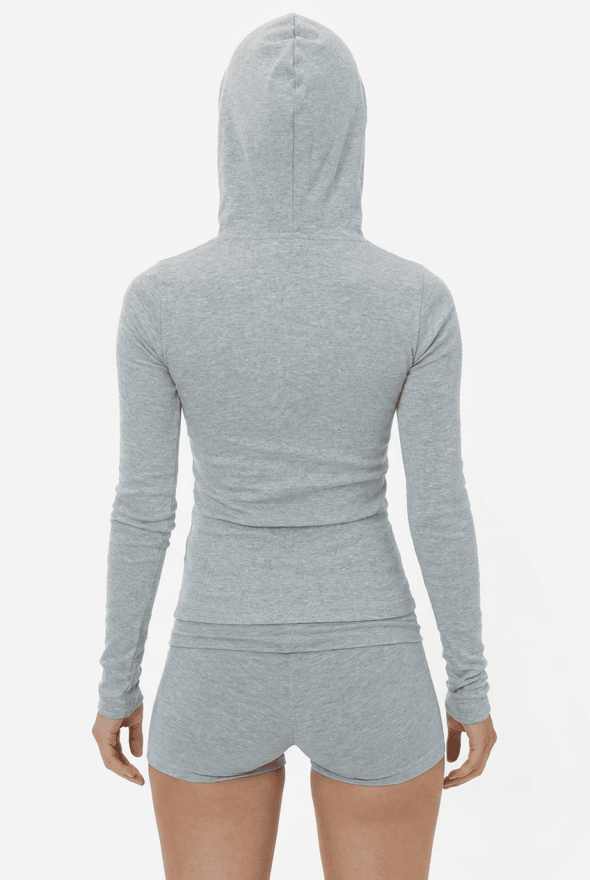 Model wearing heather grey slim-fit hooded long-sleeve top, back view with hood up and matching high-waisted shorts