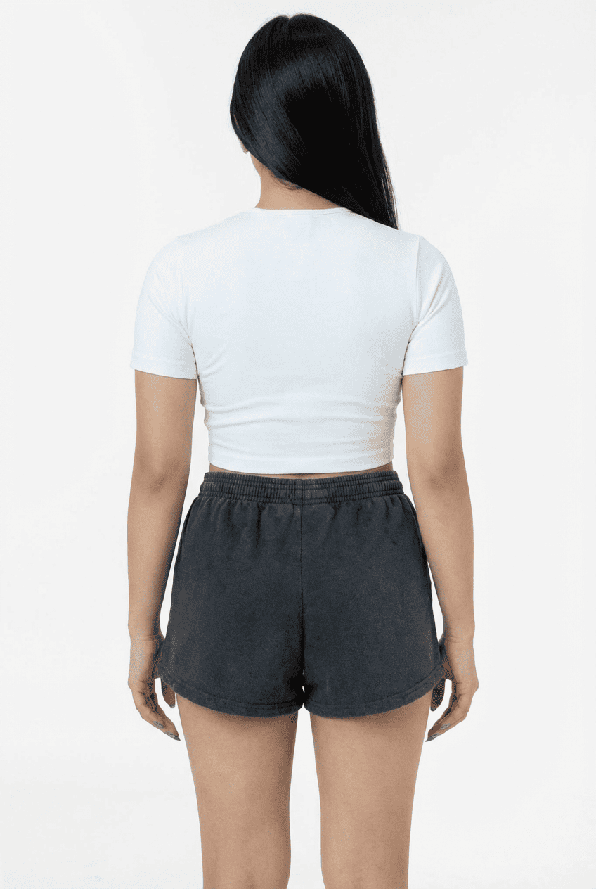 Model wearing charcoal gray washed fleece sweat shorts, back view styled with a white cropped crewneck tee