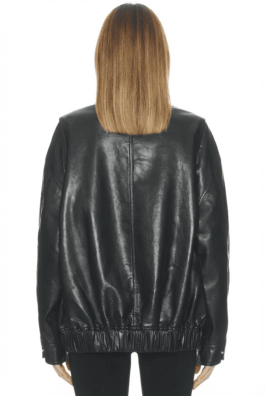 Model wearing black oversized leather jacket, back view showing elasticated hem and clean back panel