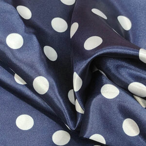 Navy blue satin fabric with white polka dot pattern