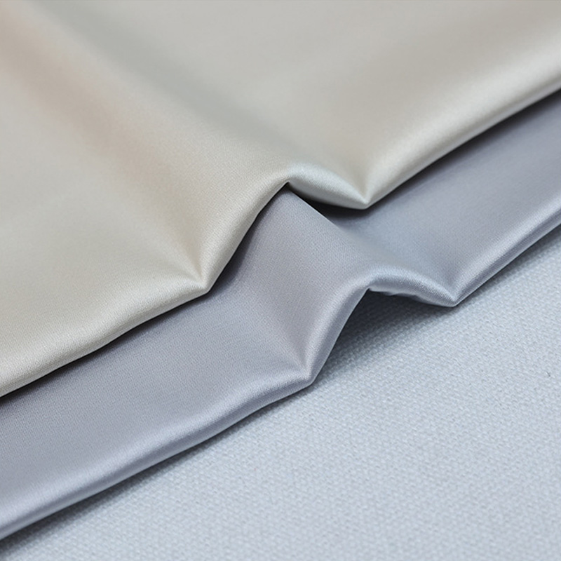 Layered stretch satin fabric showing soft drape and sheen