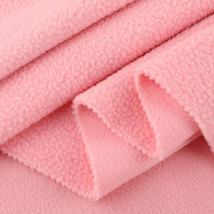 Close-up of double sided sherpa fleece fabric with soft plush texture for winter garments