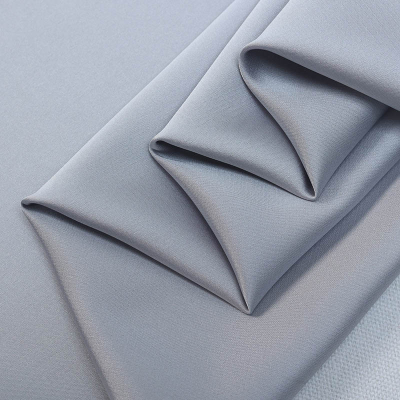 Folded satin fabric with smooth glossy finish and soft structure