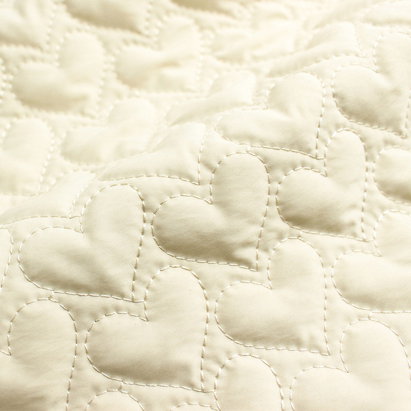Close-up texture of quilted embroidery cotton fabric