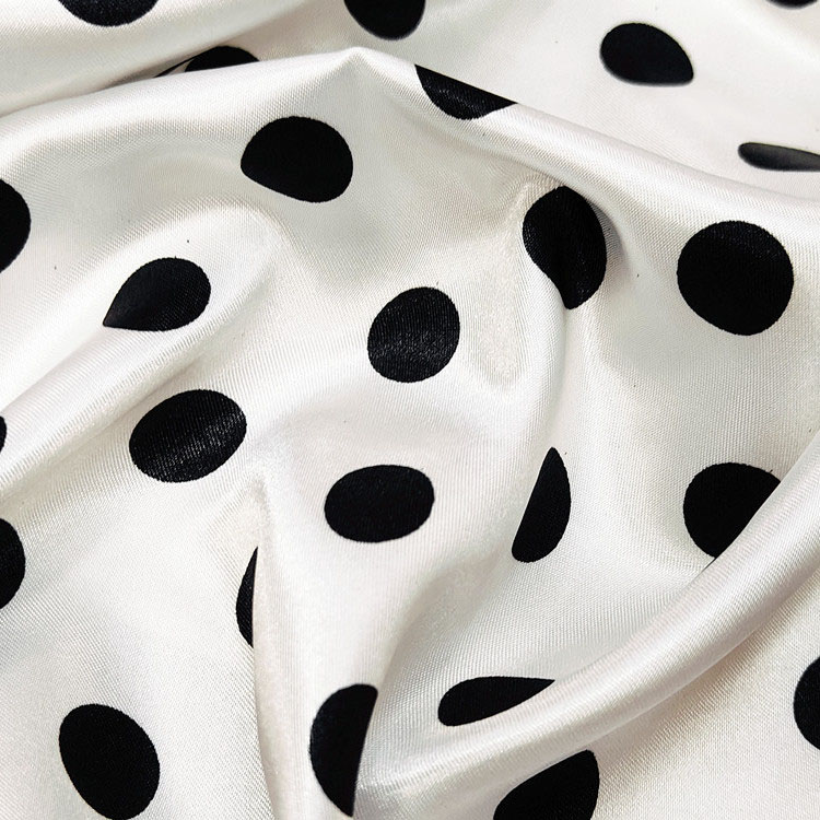 White satin fabric with black polka dot print