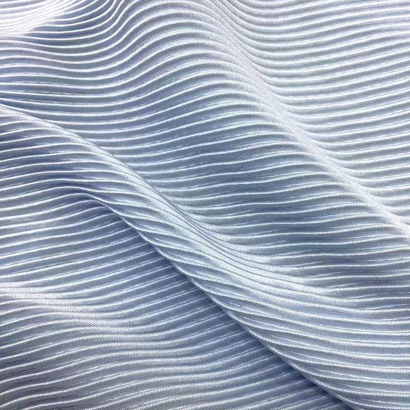 Soft blue pleated fabric with subtle shine and fine texture