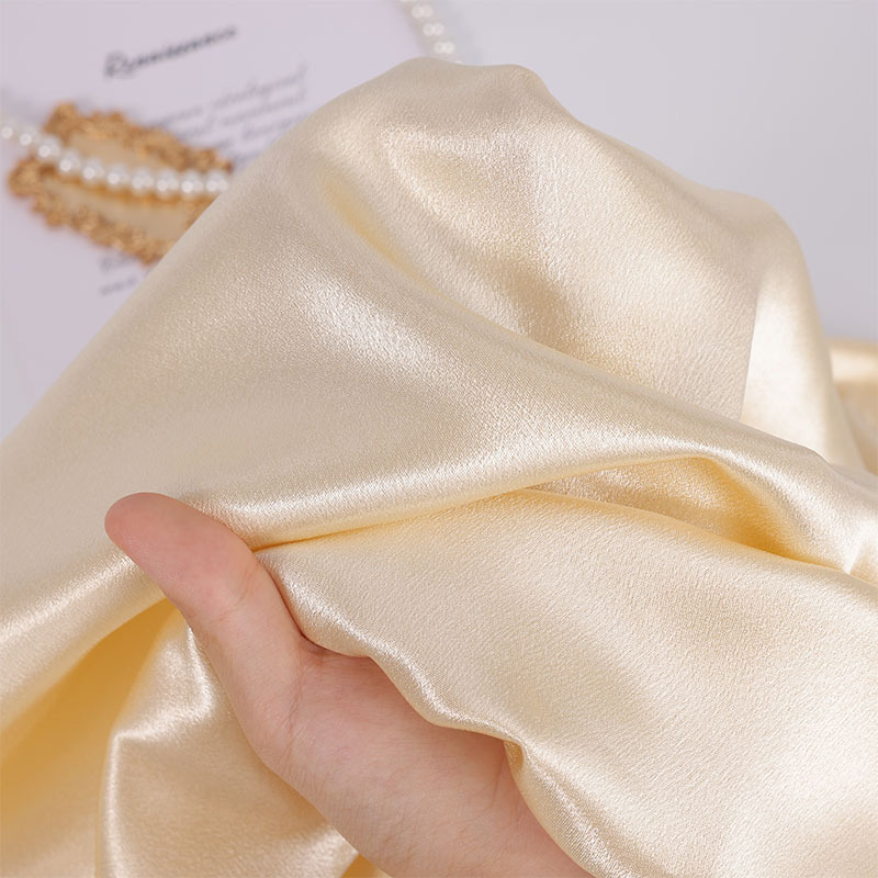 Close-up of crystal satin fabric showing soft smooth texture