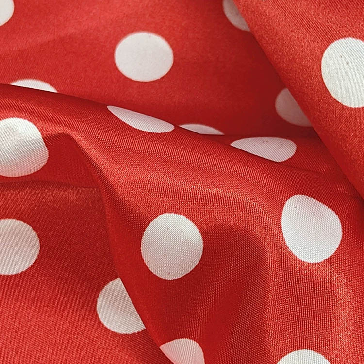 Red satin fabric with white polka dot pattern