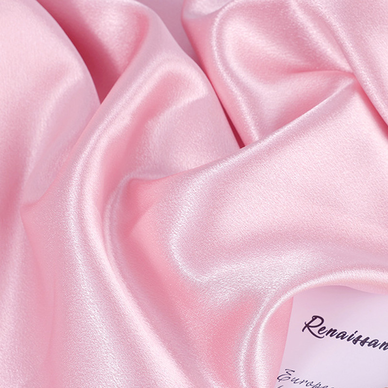 Pink satin fabric with smooth glossy finish and soft drape