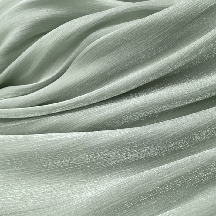 Soft green satin fabric with smooth glossy surface