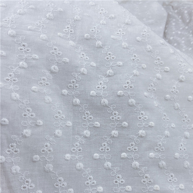Cotton lace fabric with delicate small floral embroidery pattern