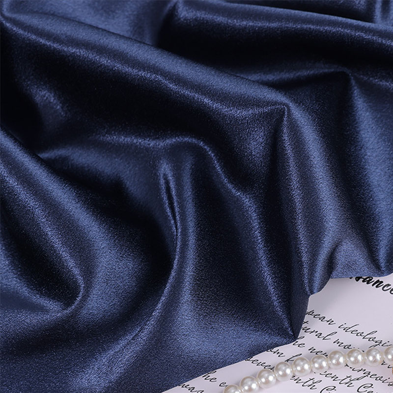 Dark satin fabric with rich glossy surface and elegant folds