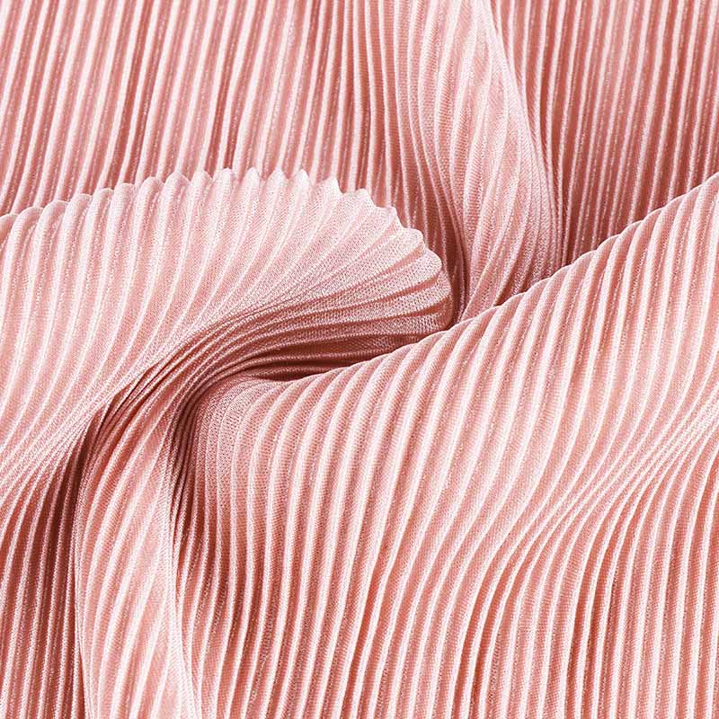 Pleated fabric in swirl shape showing flexibility and flow