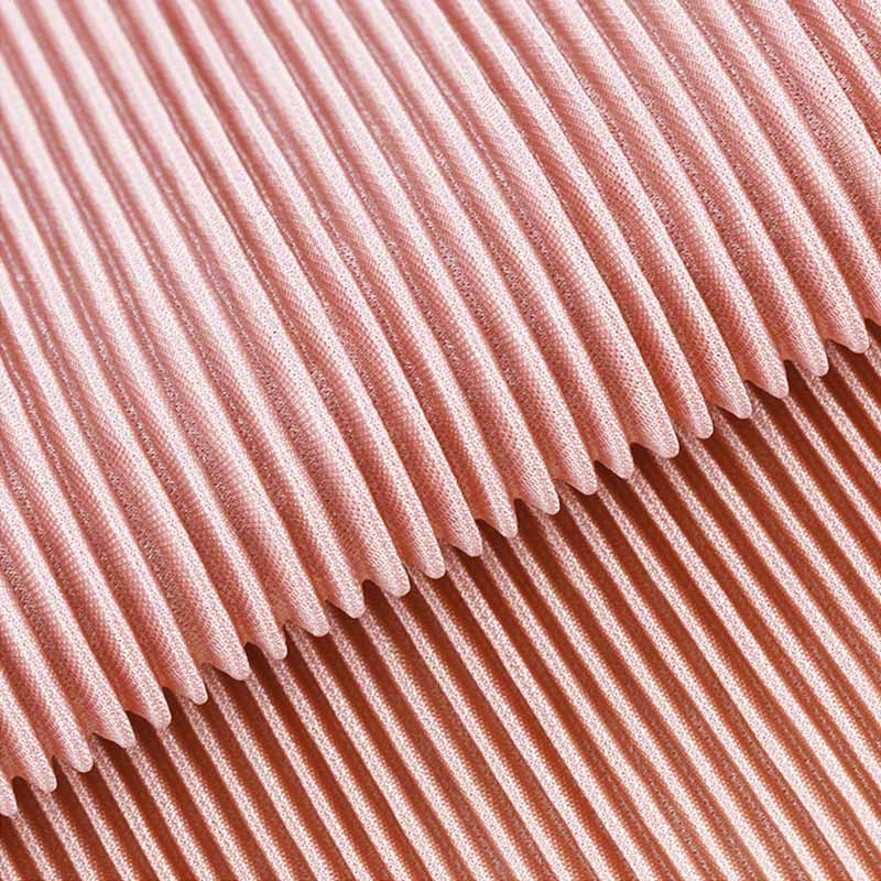 Close-up of pleated fabric with smooth texture and subtle shine