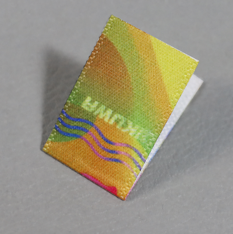 Folded custom printed fabric label with full-color design