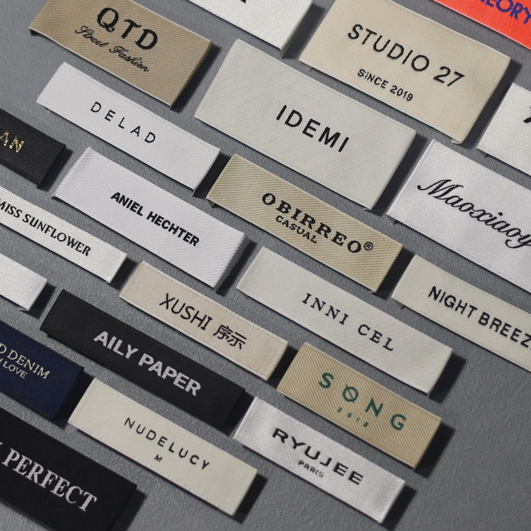 Custom woven clothing labels in different sizes, colors, and logo styles