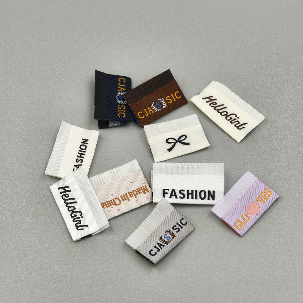 Custom woven clothing labels with logos, text, and folded designs