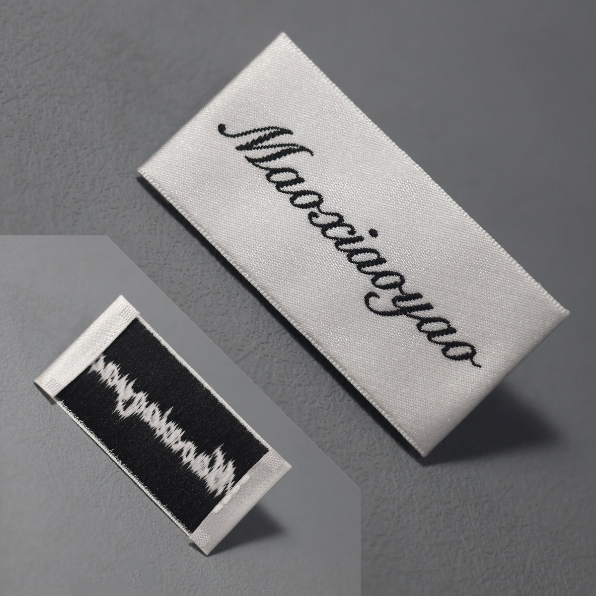Custom folded woven clothing label showing front and back sides