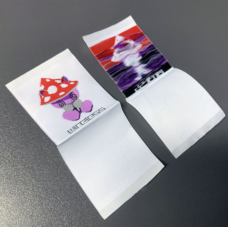 Custom woven clothing labels with colorful logos and folded design