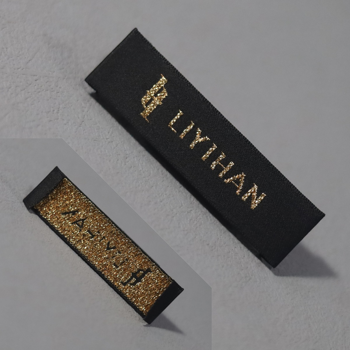 Custom black woven clothing label with metallic gold logo and text